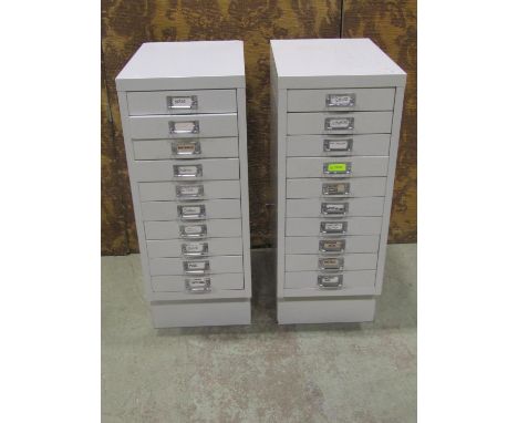 Two contemporary painted light steel floor standing filing cabinets each fitted with a tower of ten drawers set on slightly r