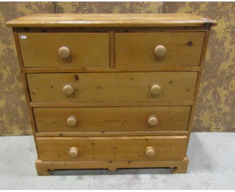 A stripped pine bedroom chest of two short over three long drawers on bracket supports, 93 cm high x 97 cm wide x 41 cm deep 