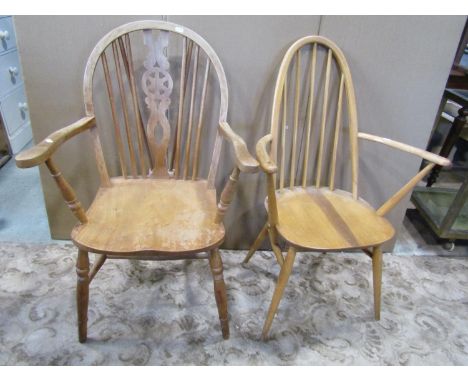 An Ercol hoop back elbow chair, together with a further Windsor wheelback armchair 