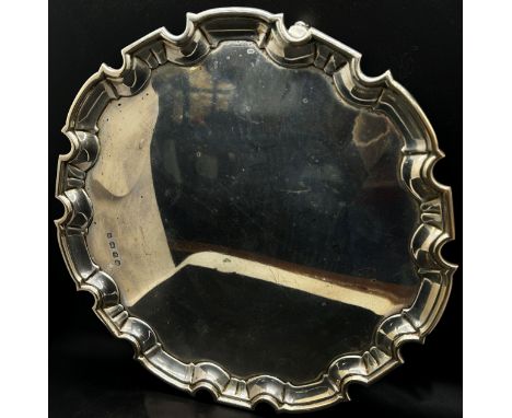 A silver scalloped edge salver, raised on scrolled supports, 30cm diam, Sheffield 1922 maker William Hutton &amp; Sons Ltd, 3