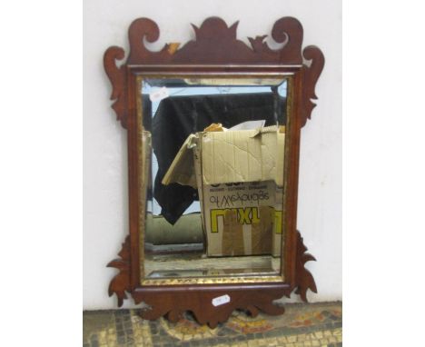 Small Chippendale style wall mirror with rectangular bevelled edge plate and gilt slip within a fret carved frame 46 cm high 