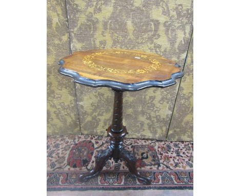 A Victorian rosewood occasional table, the shaped top with inlaid detail showing a circular floral band raised on a spiral co