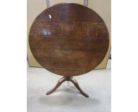 A 19th century oak snap top occasional table of circular form raised on a turned pillar and swept tripod, 82 cm diameter x 72