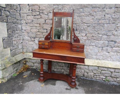 Victorian mahogany Duchess dressing table with raised swing mirror flanked by trinket drawers on turned supports, with shaped