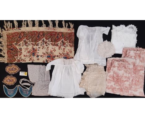 Collection of mixed textiles inc C19th hand stitched bonnet in printed cotton, a fringed shawl in fine wool print, panels for