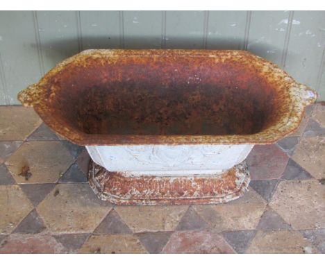 An old painted and weathered French cast iron planter of rectangular canted and tapered form with foliate detail, 63 cm long 