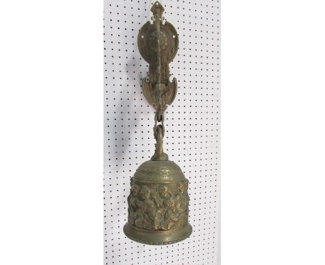 A 19th century brass porch bell, decorated with cherubs and scrolling, hung from a wall mounted bracket.