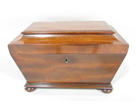 A 19th century sarcophagus two divisional mahogany tea caddy on bun feet. 
