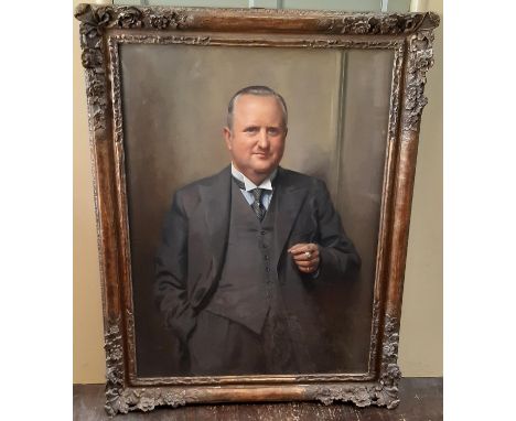John Archibald Alexander Berrie (British 1887-1962) - Three-quarter portrait of a gentleman standing in a three-piece suit ho