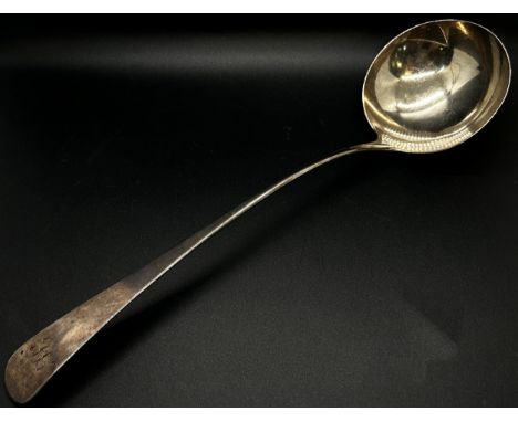 A George III silver ladle, London 1812, maker Peter &amp; William Bateman, 33 cm long and a Georgian silver serving spoon 23 