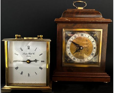 Small figured walnut mantle clock in the form of a Georgian bracket clock by Elliott of London retailed by Mappin & Webb and 