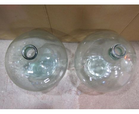 Two similar vintage light green tinted glass carboys, 55 cm high approximately 