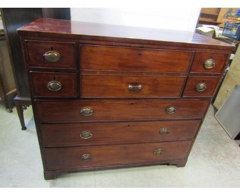 A 19th century mahogany secretaire chest, the hinged front enclosing a divisional interior, flanked by four short and above t