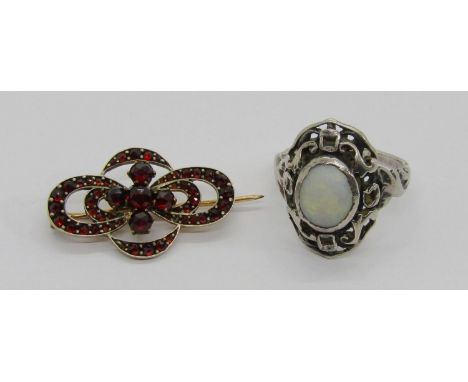 Arts &amp; Crafts style silver openwork dress ring set with a cabochon opal, size P and a Bohemian garnet yellow metal brooch