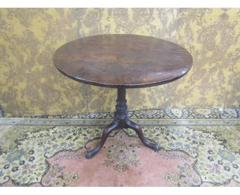 A 19th century snaptop table (birdcage action) the oak top, raised on a mahogany wrythen pillar set on a tripod base, 68cm hi