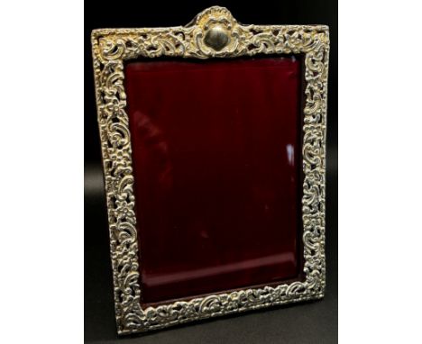 A silver portrait photo frame with scrolling detail, red leather covered back stand, 10 x 14 cm opening, Birmingham 1897, mak