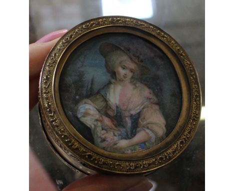 An ivory trinket box with portrait miniature to lid and gilt metal mounts, 6.5cm in diameter 