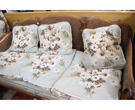 An early 20th Century carved walnut and caned bergere suite, the sofa 195cm wide 