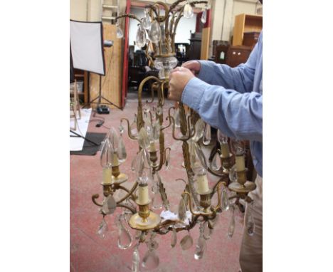 A Continental gilt metal and cut glass hung eight light chandelier