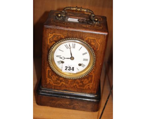 A French mantel clock mahogany cased with satinwood marquetry, bearing the makers name of Breguet, 21 cm high.