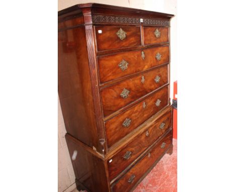 A Georgian mahogany tallboy  with blind fret frieze, two short and five long drawers, flanked by fluted canted angles on brac