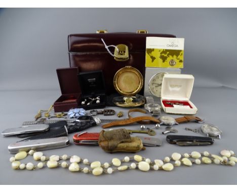 BURGUNDY TRAVELLING VANITY CASE WITH KEY containing a mixed quantity of jewellery, wristwatches, penknives, pocket watch keys