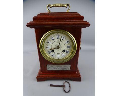 PRESENTATION MANTEL CLOCK with Roman numerals, set enamel dial and bell strike movement, the front plaque dated 1884 (now in 