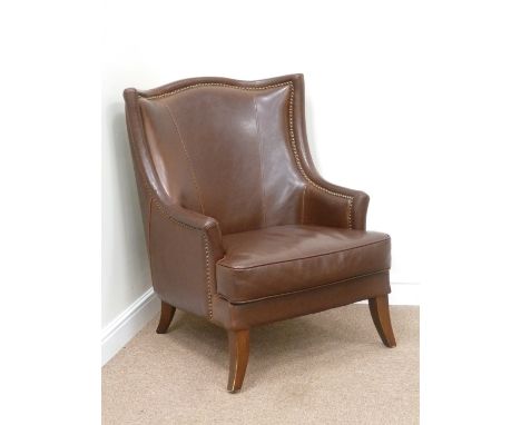 Armchair with high shaped back upholstered in burgundy studded leather with loose cushion, W72cm