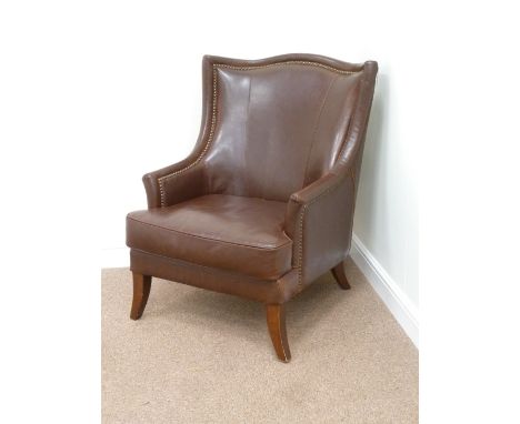 Armchair with high shaped back upholstered in burgundy studded leather with loose cushion, W72cm