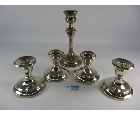 Two pairs of dwarf silver candlesticks and a single stick all hallmarked and with weighted bases