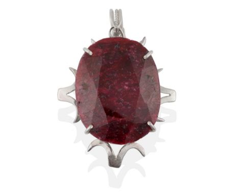 A Ruby Pendant, the oval cut ruby in a white claw setting to a scroll border, measures 5cm by 6.6cm see illustration .  The p