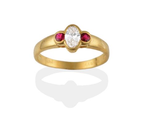 An 18 Carat Gold Diamond and Ruby Three Stone Ring, a central oval cut diamond flanked by a round cut ruby on each shoulder, 