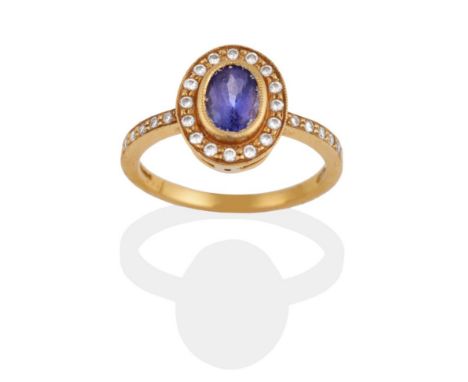 An 18 Carat Gold Tanzanite and Diamond Cluster Ring, an oval cut tanzanite within a border of round brilliant cut diamonds in