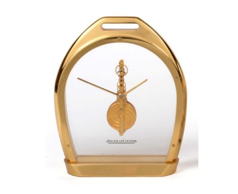 A Brass Stirrup Shaped Mantel Timepiece, signed Jaeger LeCoultre, 20th century, glazed panels with a visible single line leve