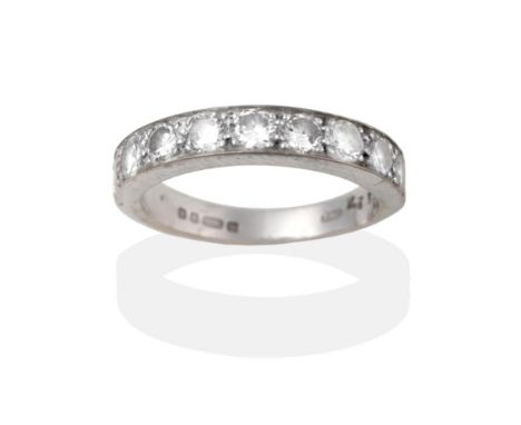An 18 Carat White Gold Diamond Half Hoop Ring, nine round brilliant cut diamonds in white claw settings to a tapering plain p