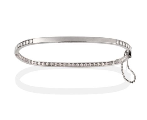 A Platinum and Diamond Bangle, the tv shaped bangle inset with five round brilliant cut diamonds to two corners, total estima