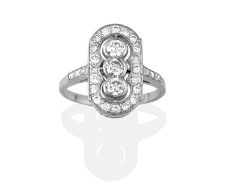 An Art Deco Style Diamond Cluster Ring, a trio of round brilliant cut diamonds in white collet settings, spaced to a border o