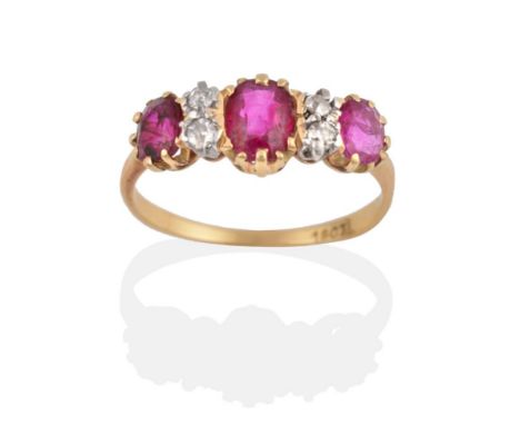 A Ruby and Diamond Ring, three oval cut rubies spaced by pairs of eight-cut diamonds, in yellow and white claw settings to a 