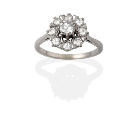 A Diamond Cluster Ring, the round brilliant cut diamonds in white claw settings to a tapered shoulder plain polished shank, t