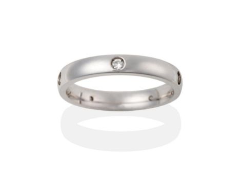 An 18 Carat White Gold Diamond Set Band Ring, the band inset with five round brilliant cut diamonds, total estimated diamond 