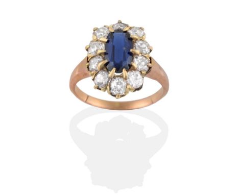 A Synthetic Sapphire and Diamond Cluster Ring, the oval cut synthetic sapphire within a border of old cut diamonds in yellow 