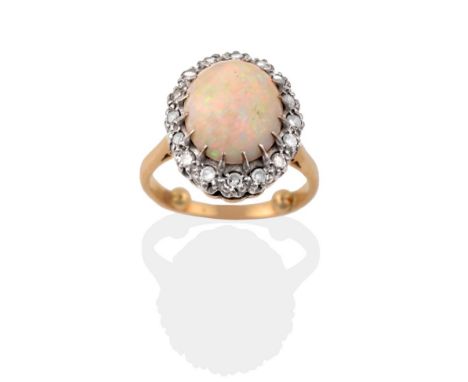 An Opal and Diamond Cluster Ring, the oval cabochon opal within a border of eight-cut diamonds in white claw settings, to a y