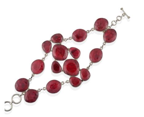 An Abstract Ruby Bracelet, mixed cut rubies in white rubbed over settings arranged in two strands and a central panel, length