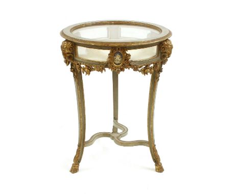 A 19th century painted and parcel gilt circular bijouterie table, with ram's head masks and inset Jasperware panels over deco