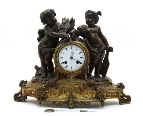 A 19th century bronzed and gilt spelter mantel clock, the white enamel dial with putti beside stamped Henry Mare A ParisCondi