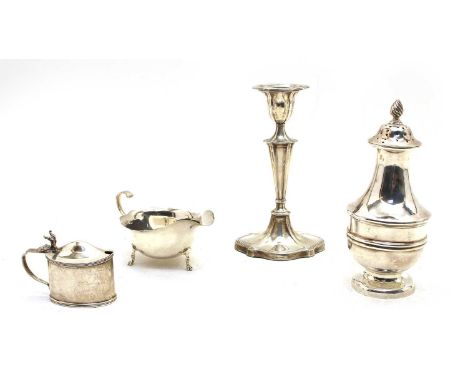 An Edwardian sugar castor, with flame finial, Sheffield 1907, 19cm high, a single candlestick, loaded base, Sheffield 1904, 1