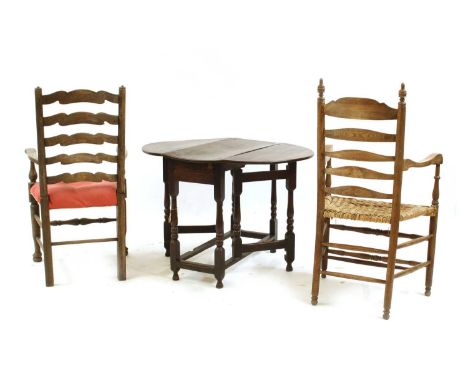 Two ash/elm ladder back armchairs, with a wicker and overstuffed seat, 62.5cm wide, and an oak drop-leaf gate leg table, 91cm