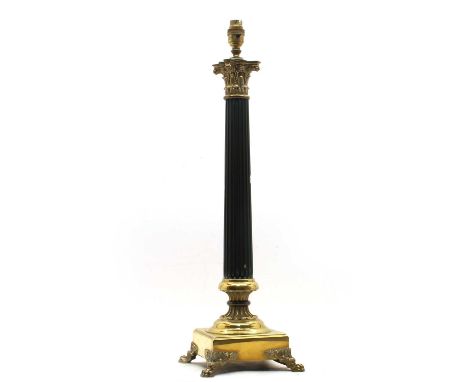 A Corinthian column table lamp, 20th century, on a square brass base and lion paw feet, 19cm wide, 63cm high, including fitti