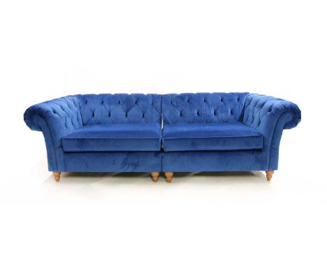 A contemporary blue velvet upholstered button back Chesterfield sofa, raised on turned wooden feet, 252cm long x 81cm highCon