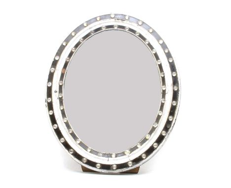 An Irish style easel dressing table mirror, the ebonised and silvered frame of oval form with facetted glass jewels around th